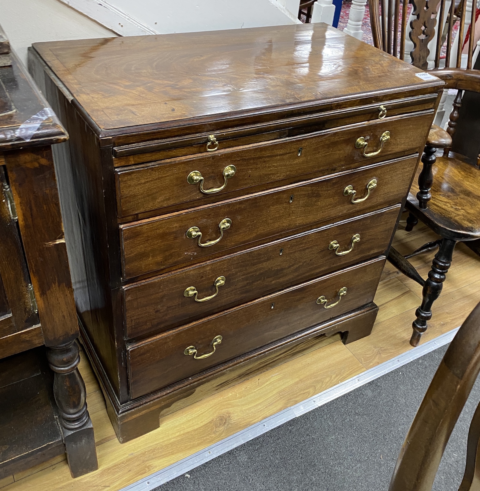 A small George III mahogany four drawer chest with brushing slide, width 86cm, depth 49cm, height 84cm